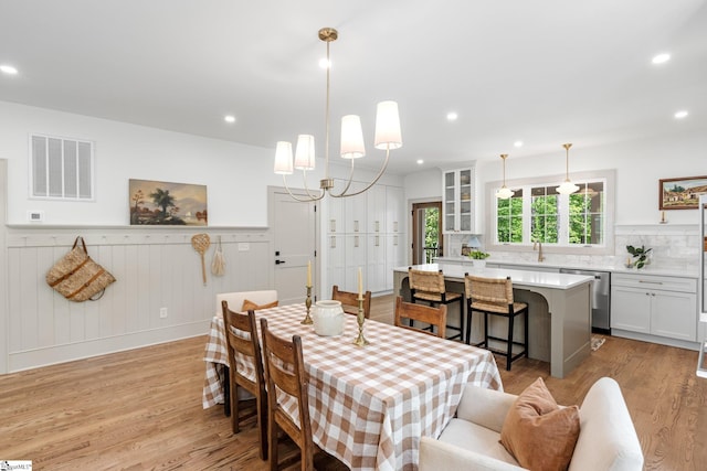 dining room with wainscoting, light wood finished floors, visible vents, and recessed lighting