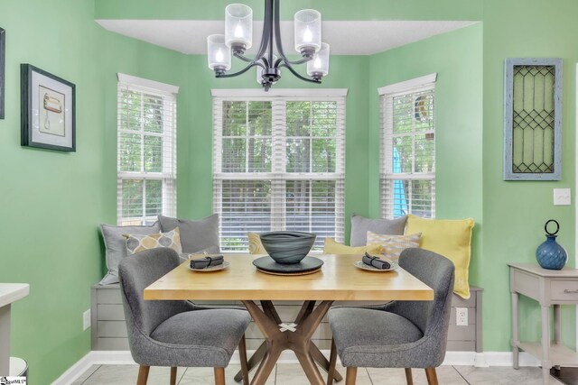 dining room featuring a chandelier, a wealth of natural light, baseboards, and breakfast area
