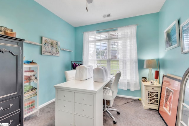 carpeted office space with visible vents and baseboards