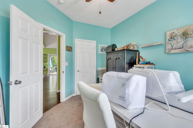 office area featuring ceiling fan, baseboards, and carpet