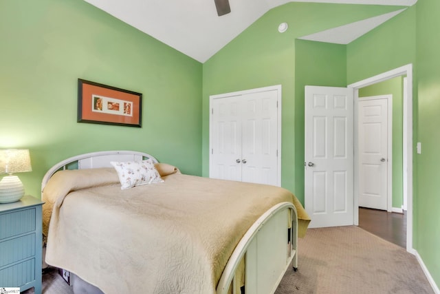 carpeted bedroom featuring lofted ceiling, a closet, baseboards, and ceiling fan