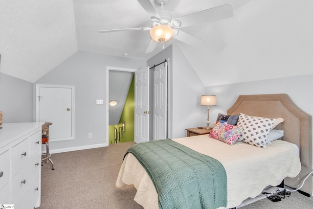 carpeted bedroom featuring lofted ceiling, a textured ceiling, and a ceiling fan