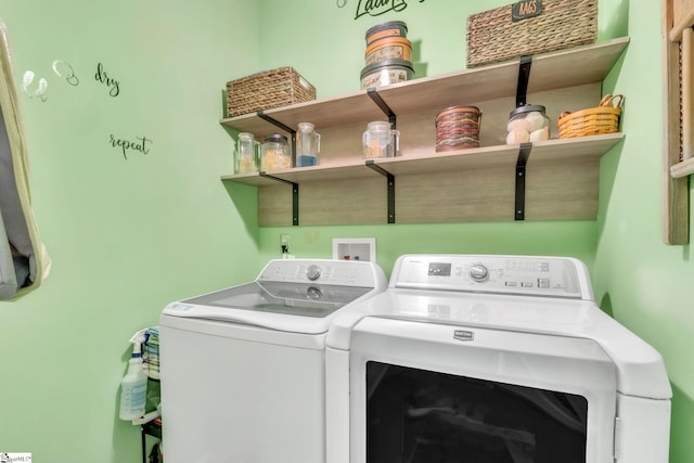 clothes washing area featuring washer and clothes dryer and laundry area