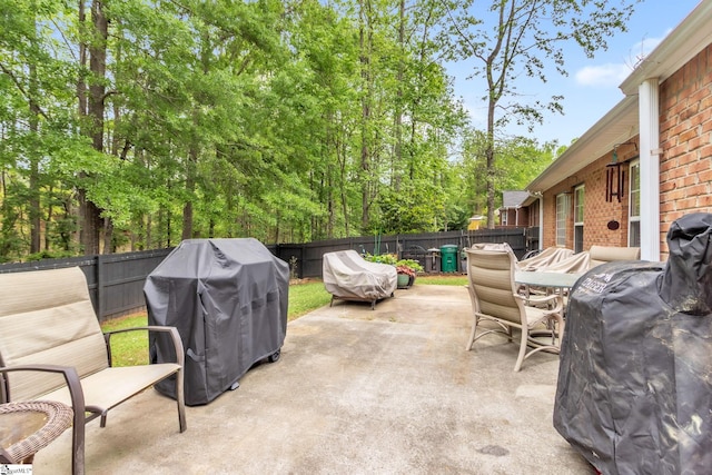 view of patio featuring grilling area, a fenced backyard, and outdoor dining area