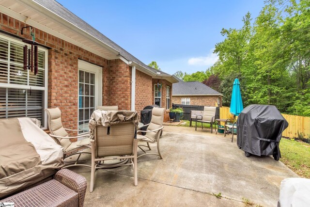 view of patio with a fenced backyard, outdoor dining area, and area for grilling