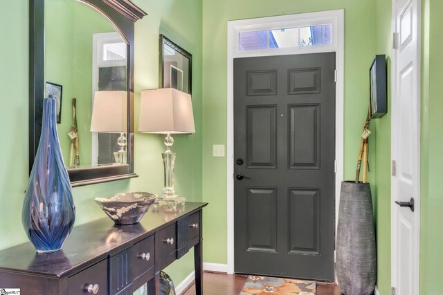 entryway with baseboards and dark wood finished floors