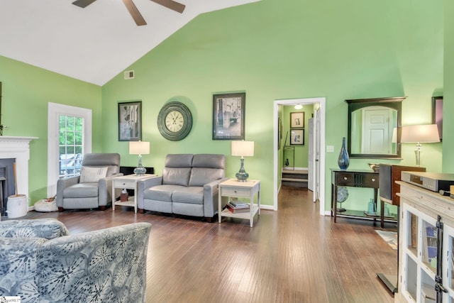 living area with wood finished floors, visible vents, a fireplace, high vaulted ceiling, and ceiling fan
