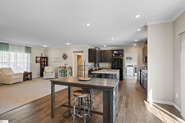 kitchen with dark brown cabinets, black refrigerator with ice dispenser, recessed lighting, and stainless steel microwave