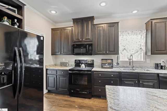 kitchen featuring a sink, black appliances, dark brown cabinetry, ornamental molding, and dark wood-style floors