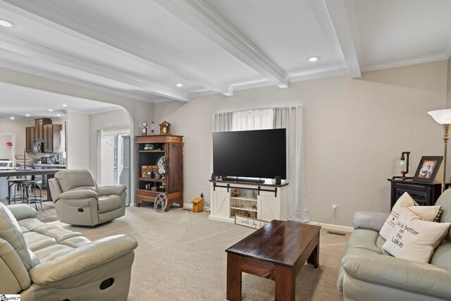 carpeted living area with beamed ceiling, arched walkways, baseboards, and recessed lighting