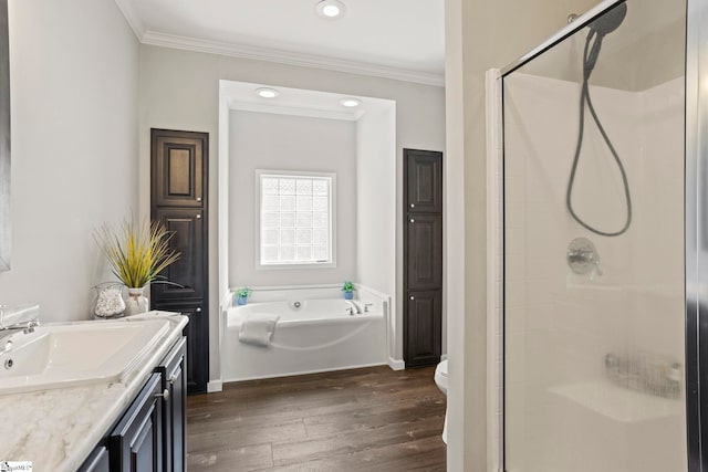 full bath with hardwood / wood-style floors, a bath, a shower stall, and crown molding