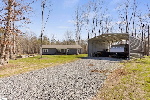 exterior space featuring a detached carport and driveway