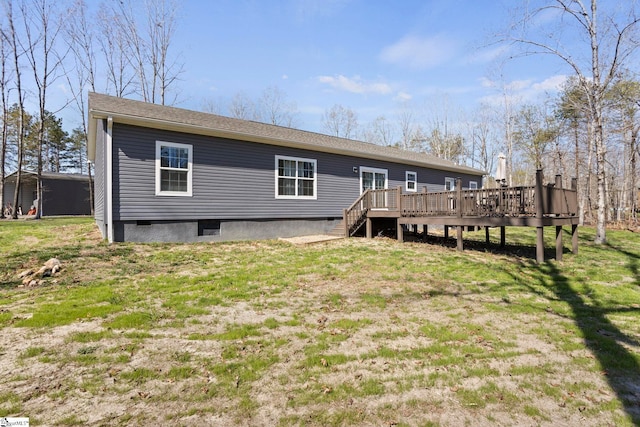 rear view of property with a yard and a deck