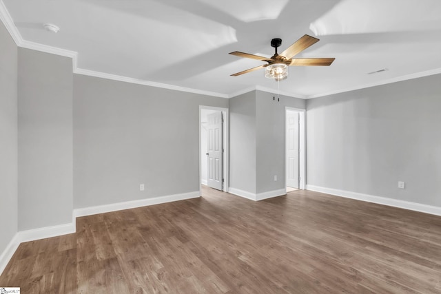 spare room with ceiling fan, baseboards, wood finished floors, and visible vents