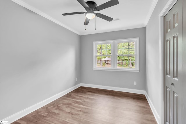 unfurnished bedroom featuring a closet, crown molding, and baseboards