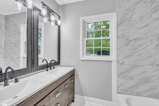 bathroom featuring baseboards, a sink, and double vanity