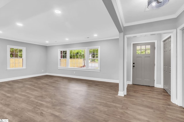 entrance foyer with plenty of natural light, baseboards, and crown molding