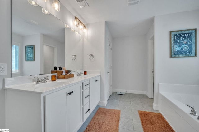 full bathroom featuring double vanity, visible vents, a sink, a bath, and baseboards