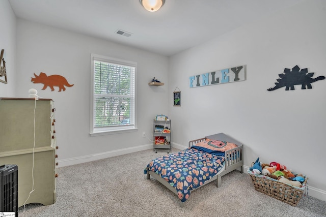 bedroom with baseboards, visible vents, and carpet