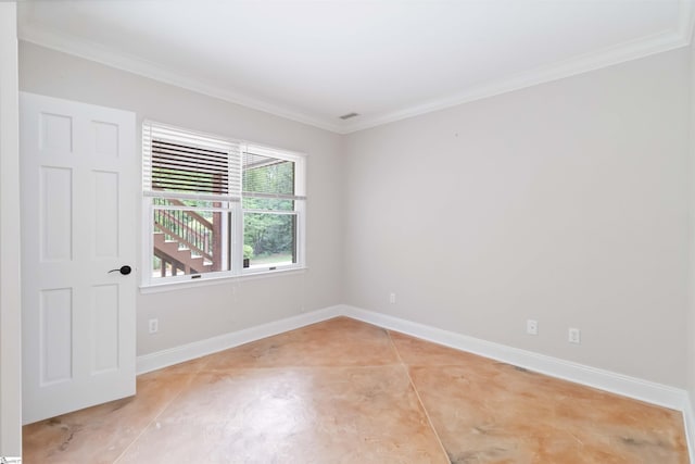 spare room with baseboards and ornamental molding