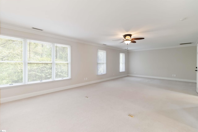 unfurnished room featuring baseboards, a ceiling fan, visible vents, and ornamental molding