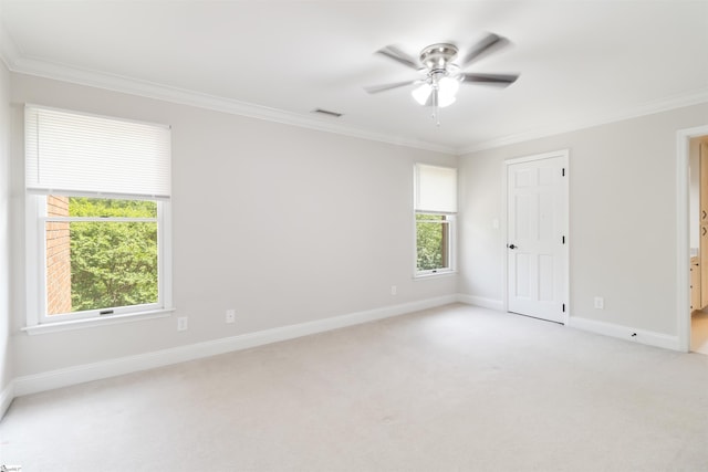 unfurnished room featuring a ceiling fan, a wealth of natural light, and crown molding