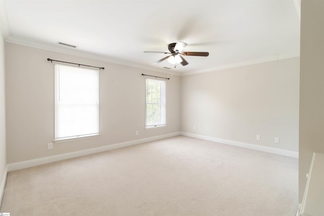 empty room featuring baseboards, a ceiling fan, crown molding, and visible vents