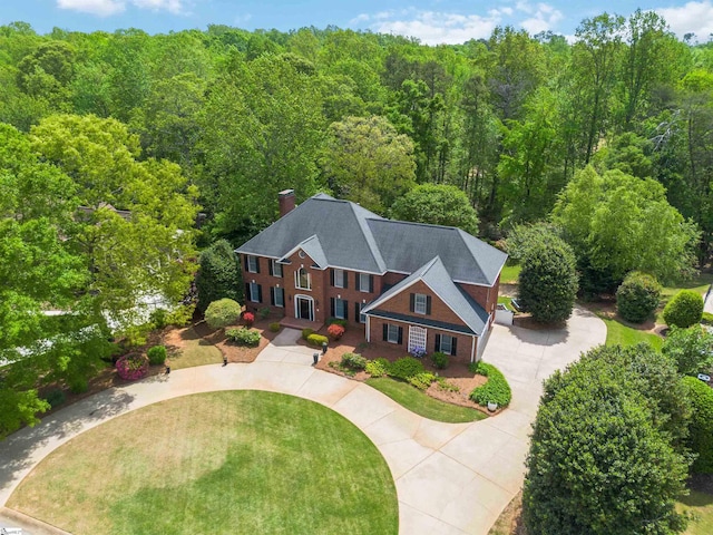 bird's eye view featuring a wooded view
