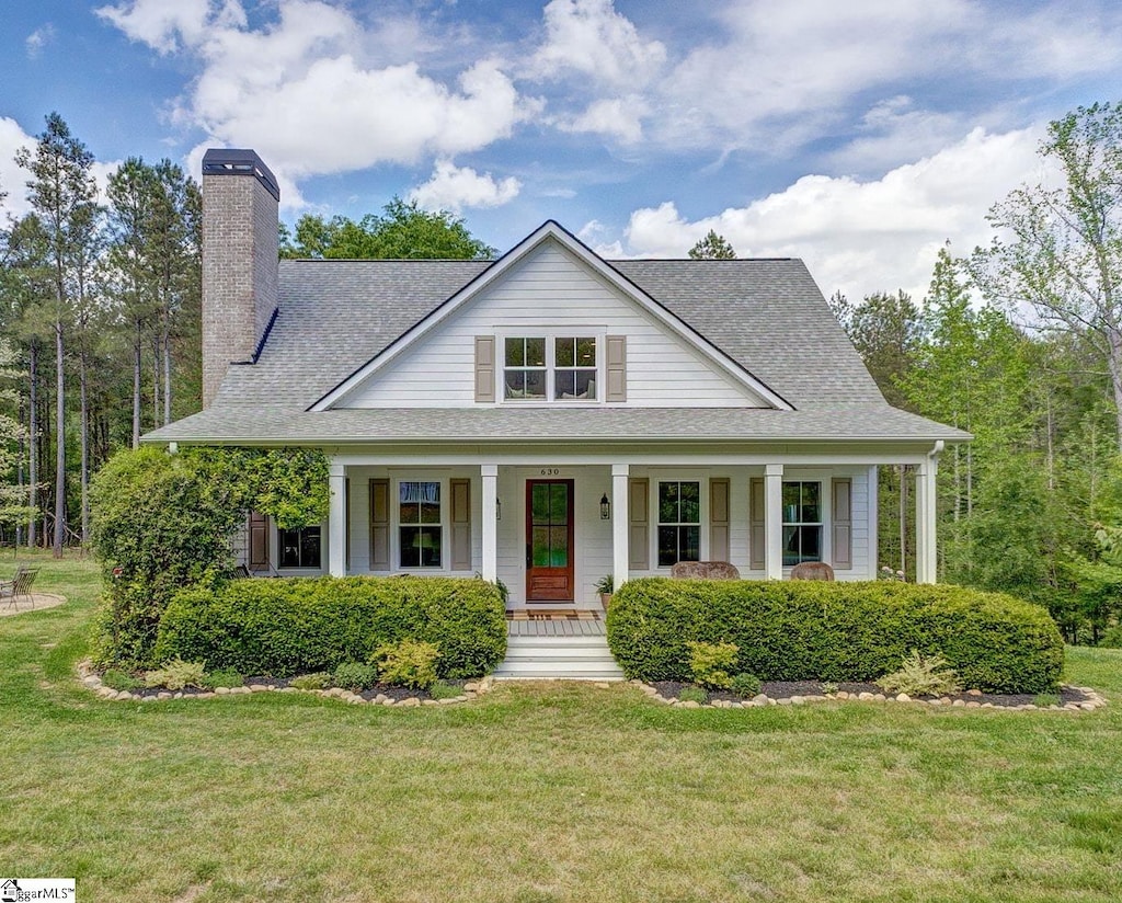 630 Pickens Dr, Pendleton, SC 29670 - view of front of house with a porch, a front lawn, a chimney, and roof with shingles