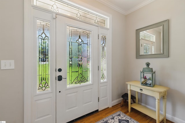 entrance foyer with wood finished floors, crown molding, and baseboards
