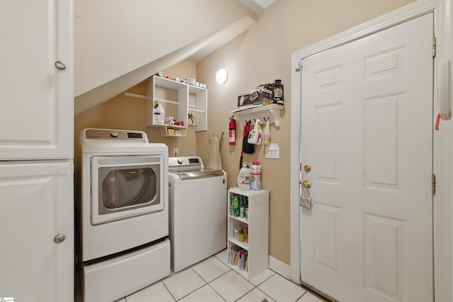 clothes washing area with washing machine and clothes dryer, laundry area, and light tile patterned floors