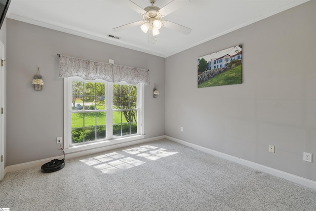 unfurnished room featuring carpet flooring, baseboards, visible vents, a ceiling fan, and ornamental molding