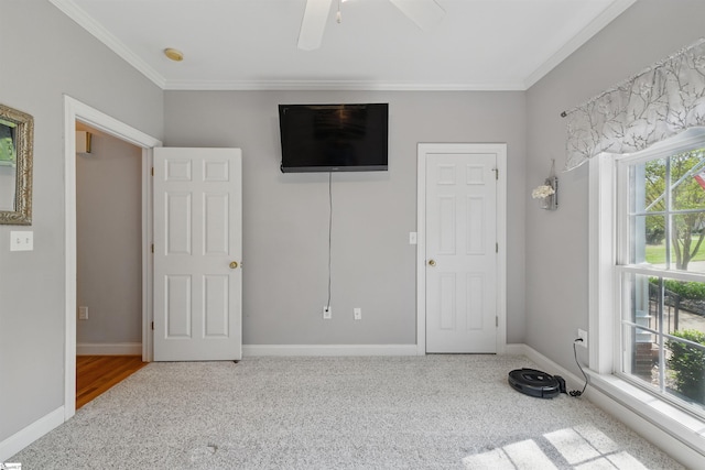 unfurnished bedroom featuring baseboards, ornamental molding, and carpet