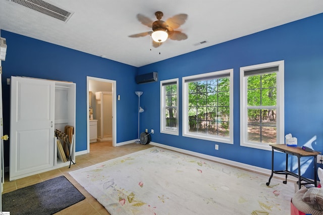 unfurnished bedroom featuring a wall mounted air conditioner, visible vents, and multiple windows