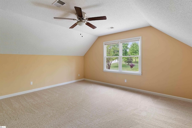 bonus room with carpet floors, a textured ceiling, and visible vents