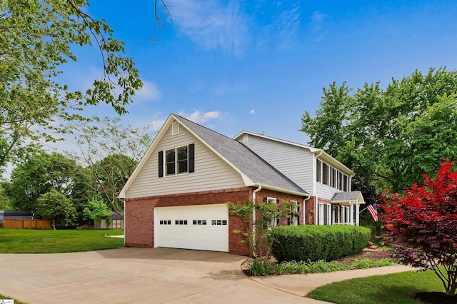 view of front of house featuring a front lawn, driveway, brick siding, a garage, and a shingled roof