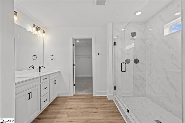 407 Briggs Dr, Easley, SC 29642 - full bath featuring double vanity, a marble finish shower, a walk in closet, and wood finished floors