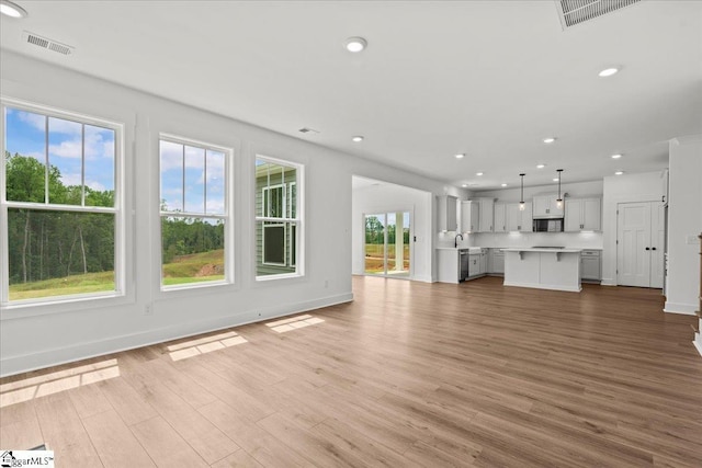 407 Briggs Dr, Easley, SC 29642 - unfurnished living room with wood finished floors, baseboards, and recessed lighting