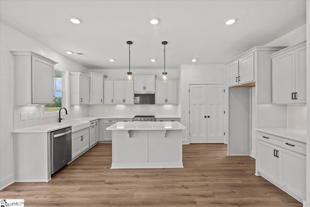407 Briggs Dr, Easley, SC 29642 - kitchen with stainless steel dishwasher, a sink, range, a kitchen island, and white cabinetry