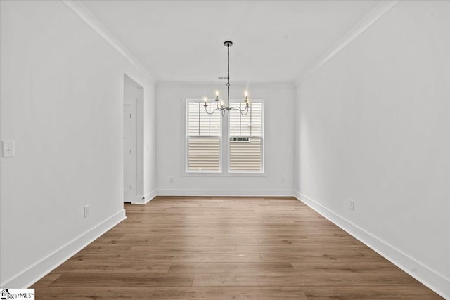407 Briggs Dr, Easley, SC 29642 - unfurnished dining area with a chandelier, crown molding, baseboards, and wood finished floors