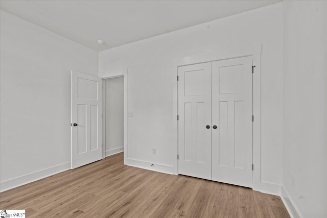 407 Briggs Dr, Easley, SC 29642 - unfurnished bedroom featuring light wood-style floors, a closet, and baseboards