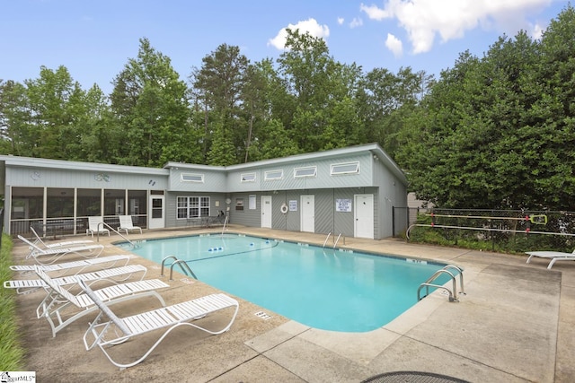 123 Sequayah Dr, Fair Play, SC 29643 - community pool with a patio area, a sunroom, and view of scattered trees