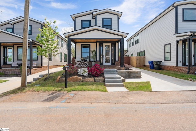 view of front facade featuring fence and a porch