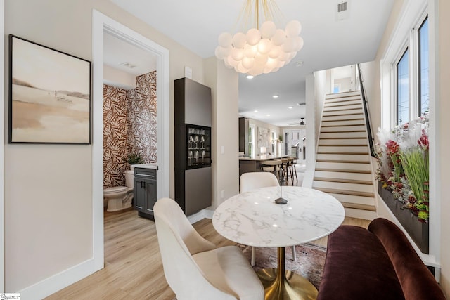 dining area with recessed lighting, stairway, light wood-style floors, baseboards, and a chandelier