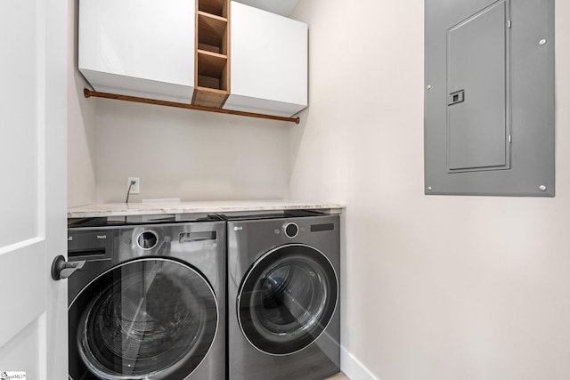 laundry room with baseboards, cabinet space, electric panel, and independent washer and dryer