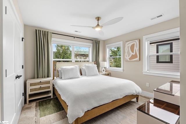 bedroom with baseboards, a ceiling fan, and visible vents