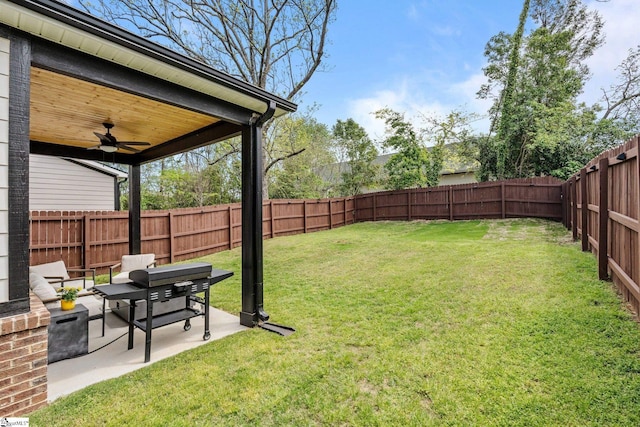 view of yard featuring a fenced backyard, a patio area, and ceiling fan