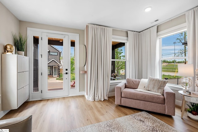 doorway to outside featuring wood finished floors, visible vents, and recessed lighting