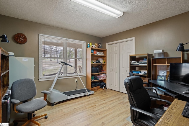 office area with wood finished floors and a textured ceiling