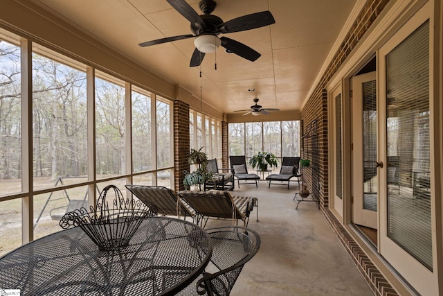 sunroom featuring ceiling fan
